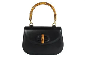 Black leather handbag with bamboo handle and lock